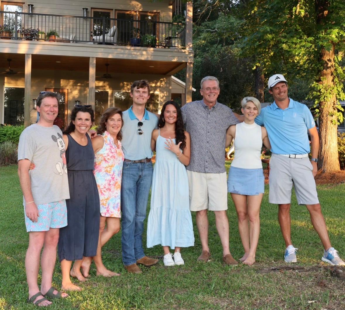 Phil Buffington with his family gathered together outdoors.